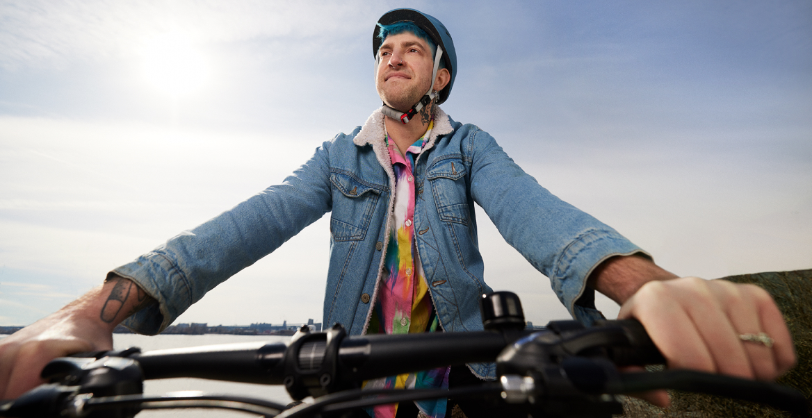 Tim, an actual BEQVEZTM (fidanacogene elaparvovec- dzkt) patient, on a bicycle with the words, "Tim, who received the BEQVEZ infusion in 2021" and "Tim participated in the BEQVEZ clinical study."