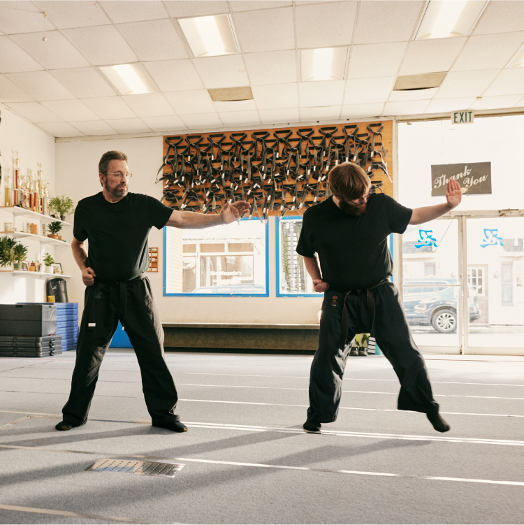 Three men engaging in martial arts