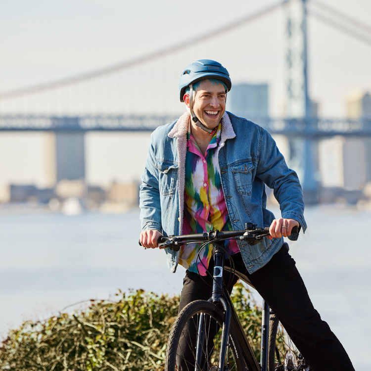 Tim, an actual BEQVEZTM (fidanacogene elaparvovec- dzkt) patient, riding a bicycle with the words, "Tim, who received the BEQVEZ infusion in 2021" and "Tim participated in the BEQVEZ clinical study."