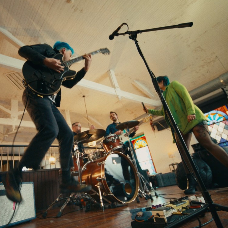 Tim, an actual BEQVEZTM (fidanacogene elaparvovec- dzkt) patient, practicing with his band with the words, "Tim, who received the BEQVEZ infusion in 2021." and "Tim participated in the BEQVEZ clinical study."